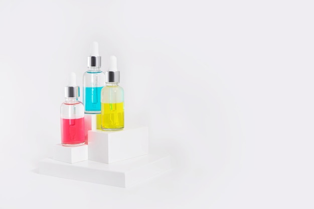 Serum with collagen and peptides in colorful glass bottles. Skincare essence for healthy skin