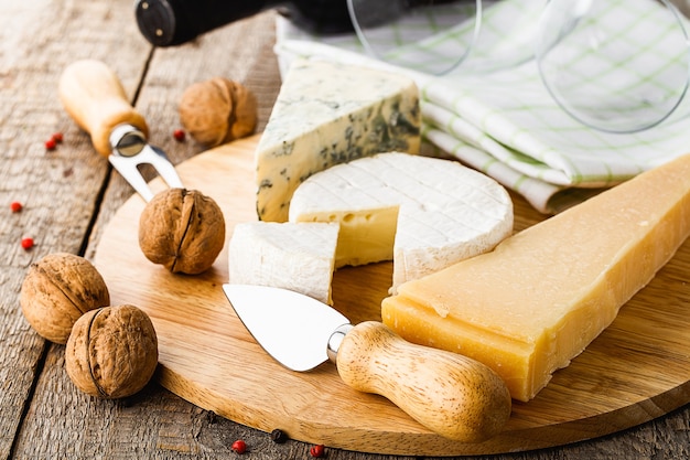 Served cheese and wine on old wooden table