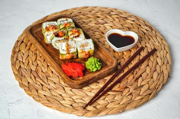 Served Japanese rolls wrapped in cucumber with spicy sauce top view  High quality photo