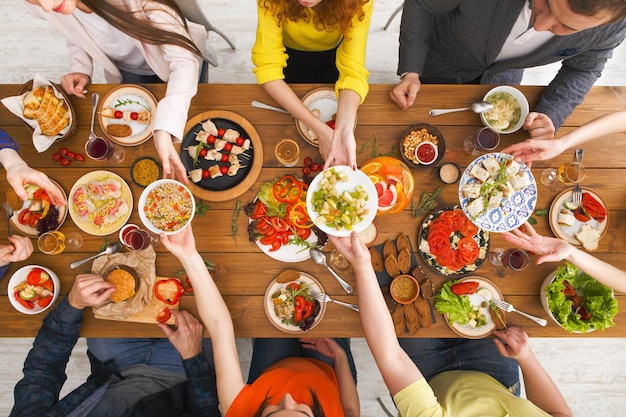 Served table top view, dinner. People eat healthy food together, home party