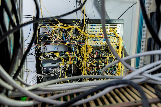 Server room with computers for internet. Network cables connected to switches.