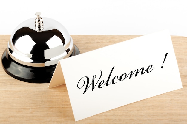 Photo service bell with blank sign at hotel desk