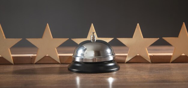 Service bell and wooden 5 stars on the wooden table