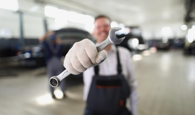 Service worker hold wrench equipment metal tool to fix vehicle