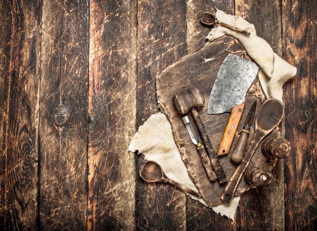 Serving background. Old kitchen tools cutting Board. On a wooden table.