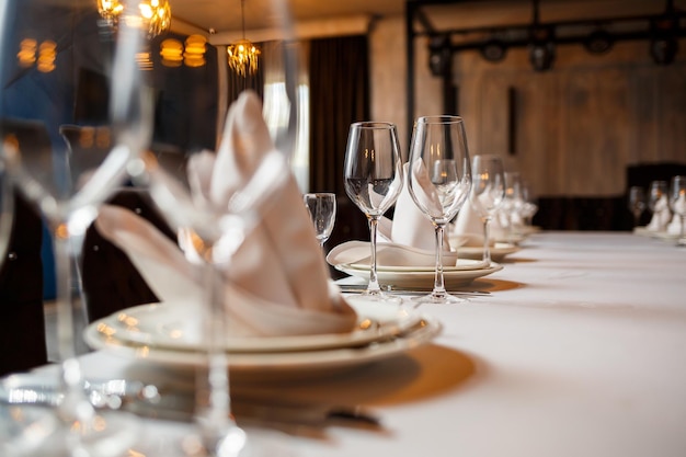 Serving a festive table in a restaurant Preparation of a banquet for a holiday Expensive decoration materials Dishes for food and drinks