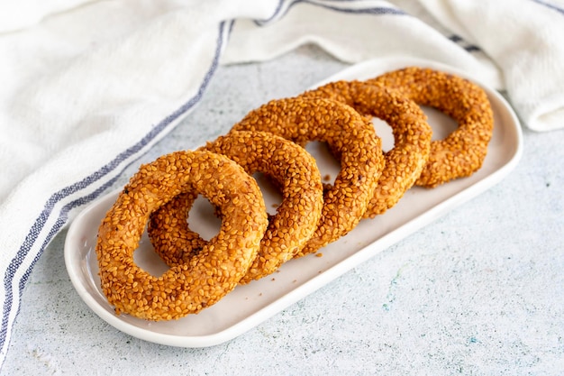 Sesame bagel on a gray background Traditional Turkish cuisine delicacies local name kandil simidi