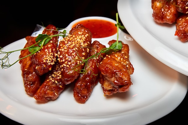 Sesame fried chicken wings with sauce and parsley