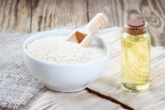 Sesame oil in a glass bottle and seeds