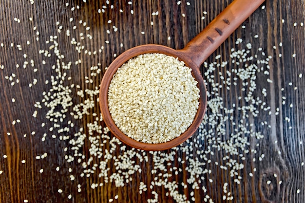 Sesame seeds in ladle on board top