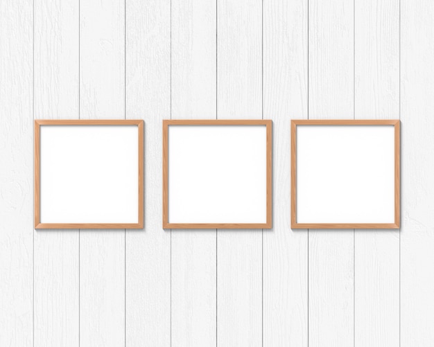 Set of 3 square wooden frames mockup hanging on the wall. Empty base for picture or text. 3D rendering.