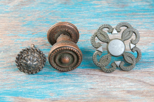 Set of 3 vintagel metal drawer pull knobs, furniture dresser handle on wooden background