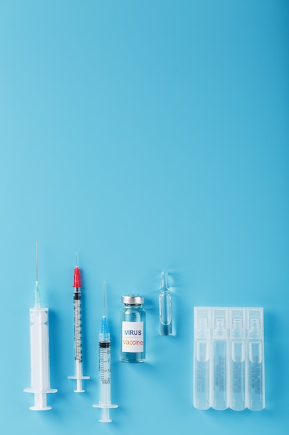 A set of ampoules and syringes with the inscription Virus vaccine and a set of syringes