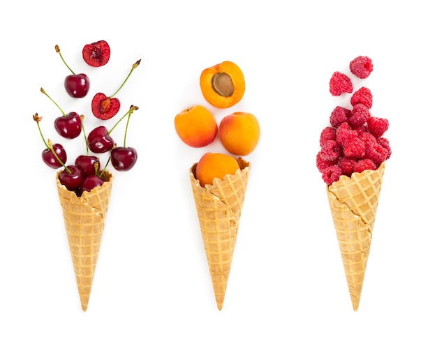 Set of assorted berries and fruit in waffle ice cream cone isolated on white background Concept of healthy eating