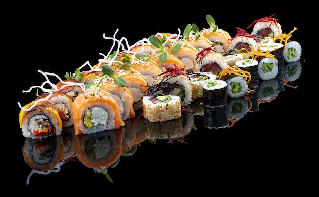 A set of assorted large sushi rolls on a glossy black background