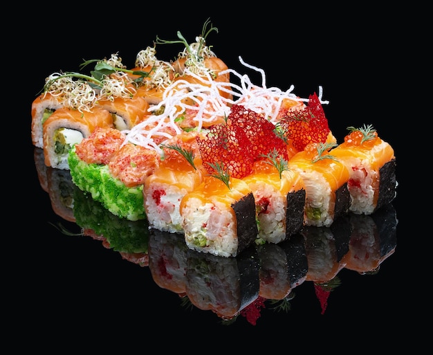 A set of assorted large sushi rolls on a glossy black background