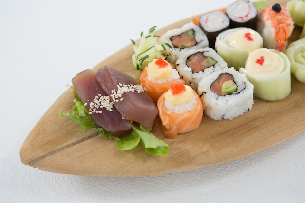 Set of assorted sushi served on wooden tray