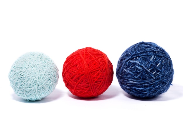 a set of balls of thread for knitting, isolate, homemade needlework, three multi-colored skeins of wool yarn