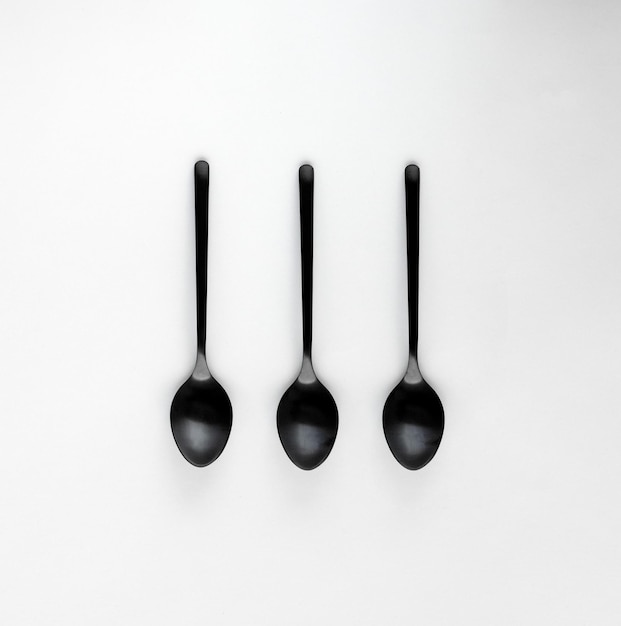 A set of black teaspoons isolated on a white background