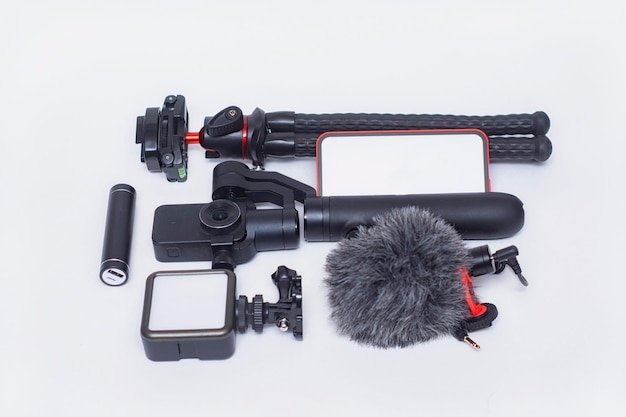 Set of blogging gadgets Smartphone mockup with a white screen with a tripod power bank with an action camera and a stabilizer with a microphone on a white background