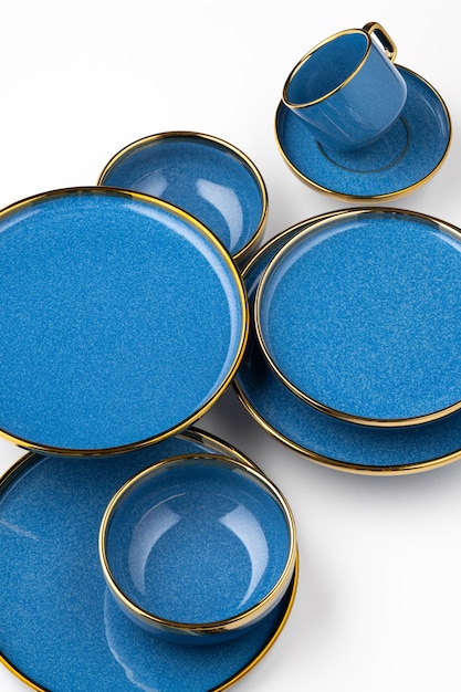 A set of blue ceramic plates and cup on a white background