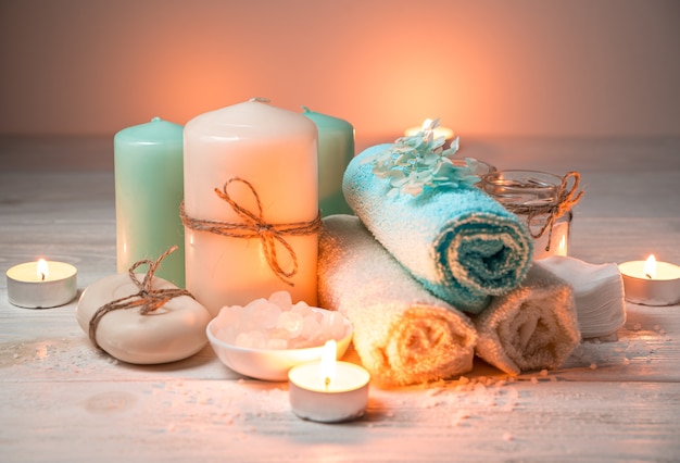 A set of body care products with burning candles.