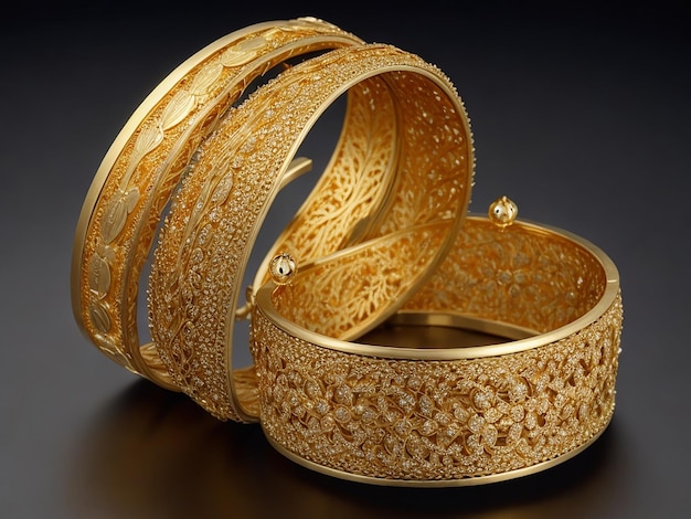 set of bold gold bangles and set of thin gold bangles with the reflection of it on a glass top