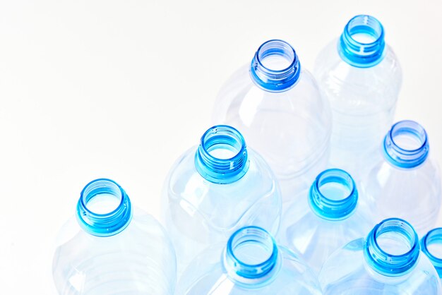 Photo set bottles of mineral water different types and sizes stand isolated on white background. 