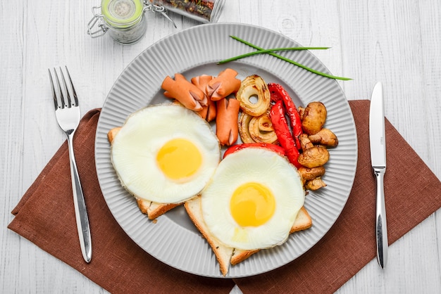 Set for breakfast fried eggs, grilled vegetables and sausages