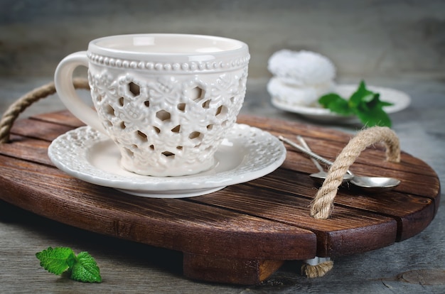 Set of ceramic tableware on a wooden tray. Kitchen interior