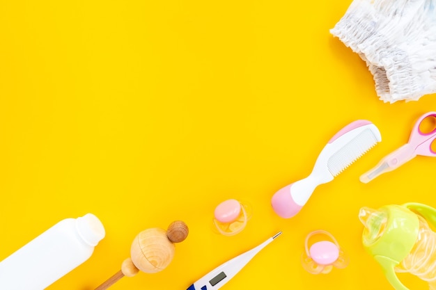 Set for children's hygiene on a yellow background, top view, flat lay, copy space