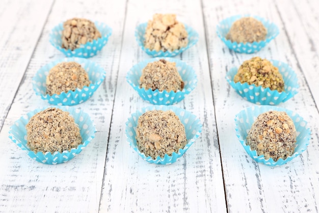 Set of chocolate candies, on wooden background