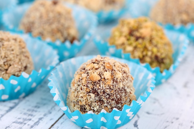 Set of chocolate candies, on wooden background