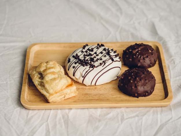 Set of chocolate donuts and puff pie.