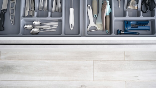 Set of clean kitchen utensils in drawer, place for text. Flat lay.