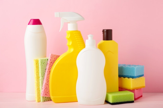 Set of cleaning tools on a pink background.