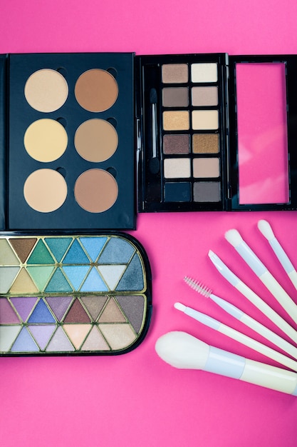 Set of colorful cosmetics on pink table