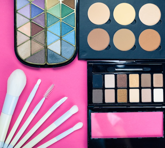 Set of colorful cosmetics on pink table