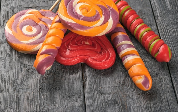 A set of colorful lollipops on sticks on a wooden table Minimal concept of sweet life and love