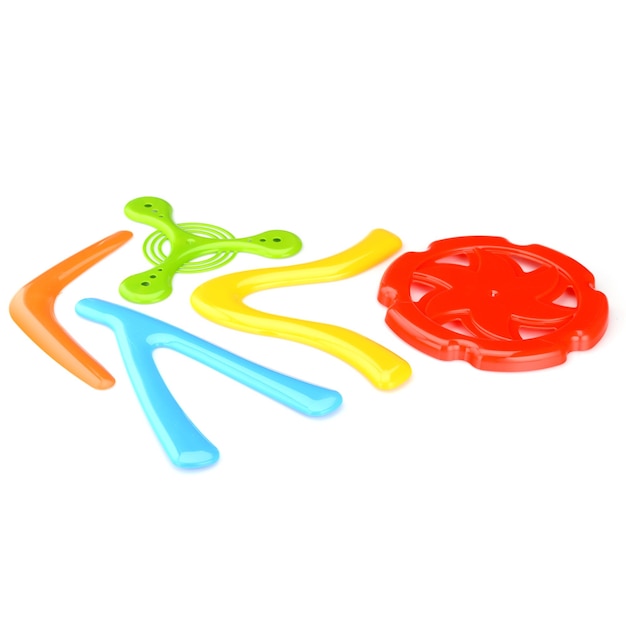 A set of colorful plastic boomerangs and frisbees for outdoor play Children's active games Boomerang isolated on a white background closeup