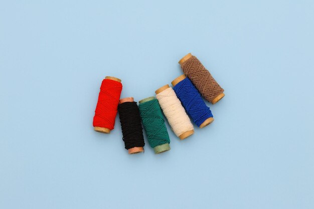 A set of colorful thread on a yellow background