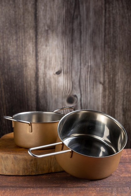 Set of cookware on the table Metallic pans