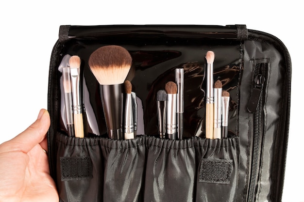 Set of cosmetic brushes in black case isolated on white background