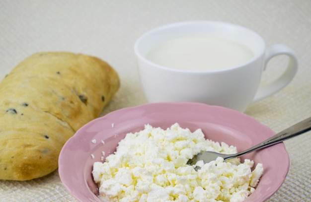 A set of dairy products and bread on a light background