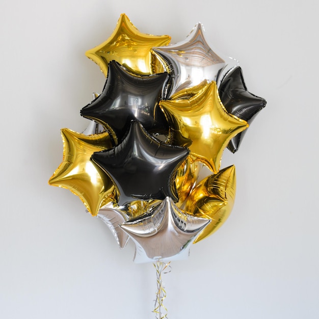 Set of deep black and gold helium balloons stars