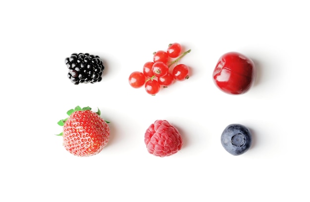 Set of different berries on a white background such as strawberries cherries raspberries blueberries currants blueberries