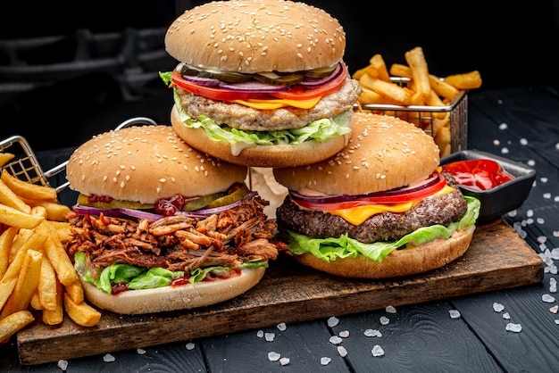 Set of different burgers with french fries Burger with chicken beef and smoked pork