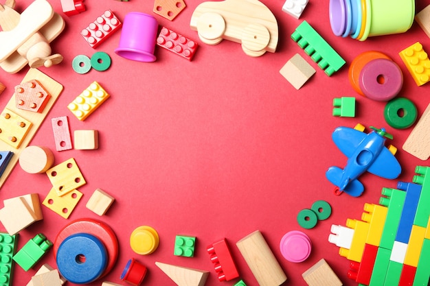 Set of different childrens toys on a colored background top view