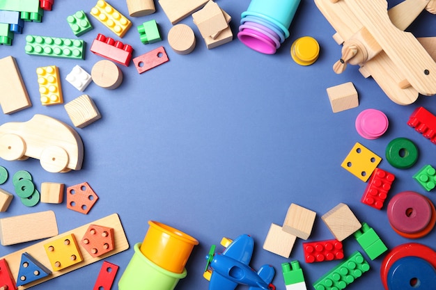 Set of different childrens toys on a colored background top view