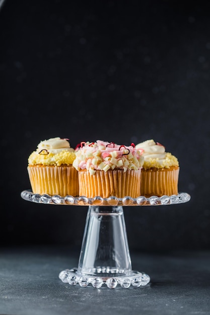 Set of different delicious cupcakes on funny cakestand